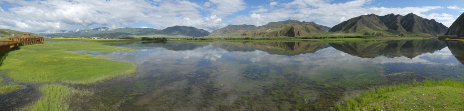 Beautiful landscape in western China Mountains clouds blue sky and mirroring christal clear lake