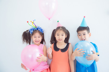 Group of adorable asian kids having fun at birthday party