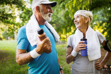 Mature couple jogging and running outdoors in city