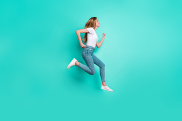 Fototapeta na wymiar Profile side full size photo of nice girl running smiling isolated over teal turquoise background