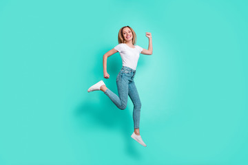 Fototapeta na wymiar Full body photo of cute lady running with toothy smile isolated over teal turquoise background