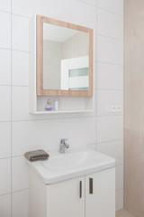 Contemporary bathroom interior with mirror and cabinet