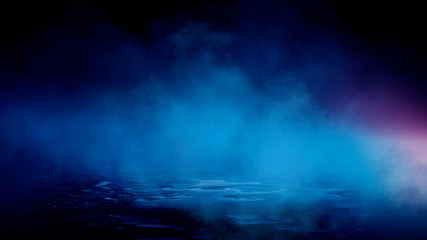 Wet asphalt, reflection of neon lights, a searchlight, smoke. Abstract light in a dark empty street with smoke, smog. Dark background scene of empty street, night view, night city.