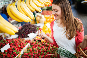 Picture of woman at marketplace buying vegetables © NDABCREATIVITY
