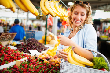 Young woman shopping healthy food on the market