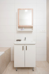 Obraz na płótnie Canvas Contemporary bathroom interior with mirror and cabinet