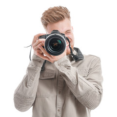 Young male photographer on white background