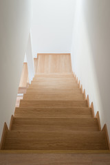Fototapeta na wymiar Wooden stairway in modern house from above