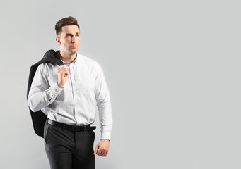 Fashionable young man on grey background