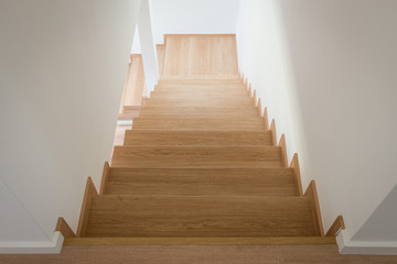 Wooden stairway in modern house from above