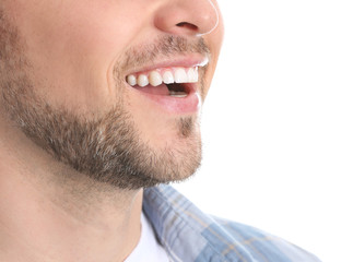 Man with healthy teeth on white background, closeup