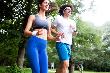 Obraz premium Happy young people jogging and exercising in nature