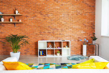Stylish interior of modern living room with brick wall