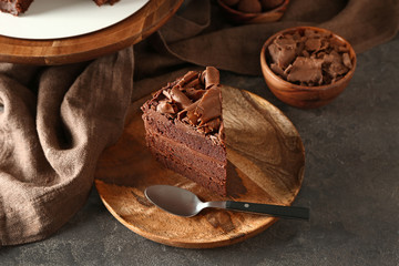 Plate with piece of tasty chocolate cake on table