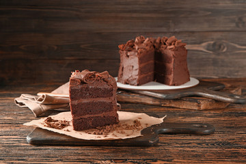 Piece of tasty chocolate cake on wooden table