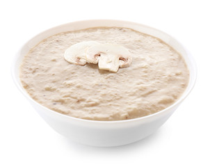 Bowl of tasty mushroom cream soup on white background
