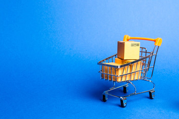 Supermarket cart with boxes, merchandise. the concept of buying and selling goods and services,...