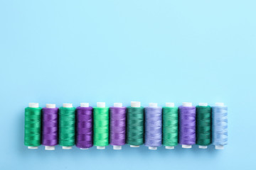 Many sewing threads on color background