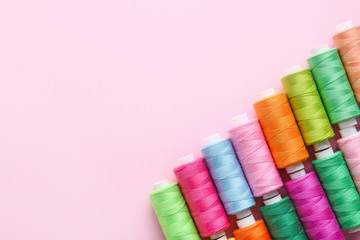 Many sewing threads on color background