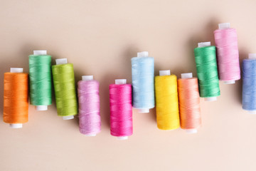 Many sewing threads on color background