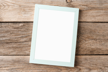 Photo frame with copyspace on wooden background