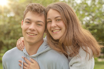 Fototapeta premium Christian friendship. Two happy friends laughing and hugging outdoors.