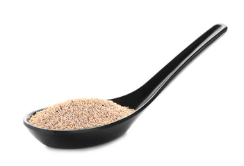 Spoon with poppy seeds on white background