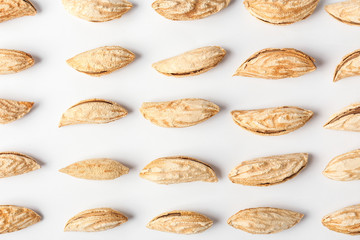 Unpeeled almond nuts on white background