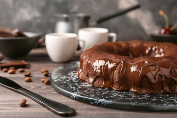 Plate with tasty chocolate cake on table