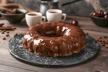 Plate with tasty chocolate cake on table