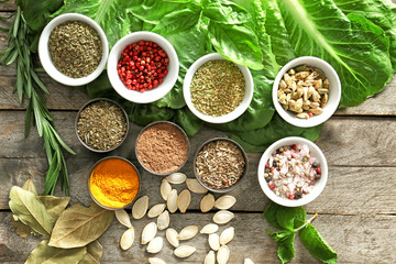 Different herbs and spices on wooden background