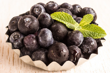 Healthy food concept: frozen blueberries on white background