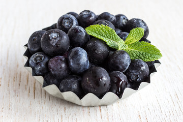 Healthy food concept: frozen blueberries on white background