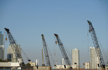 Fototapeta na wymiar A sight of a sky and a crane on the construction site