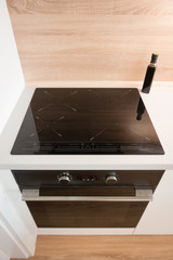 Electric stove with induction cooktop in contemporary kitchen