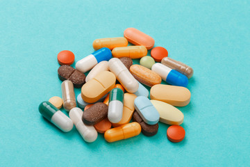 colour tablets and pills on blue background .