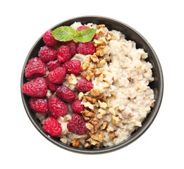Bowl with tasty sweet oatmeal on white background