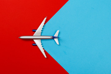 top view photo of toy airplane over color  background . travel concept .