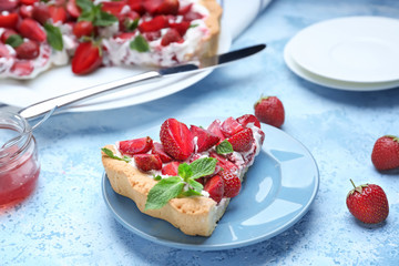 Plate with piece of tasty strawberry cake on table