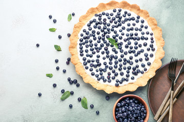 Tasty bilberry pie on table