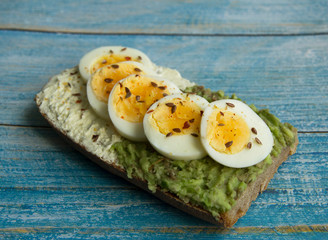 Sandwich with avocado paste, cottage cheese and sliced boiled egg
