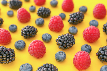 Sweet ripe berries on color background