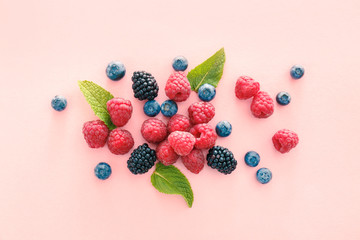 Sweet ripe berries on color background