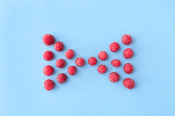 Composition with sweet ripe raspberry on color background