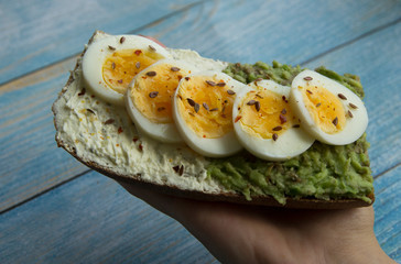 Sandwich with avocado paste, cottage cheese and sliced boiled egg
