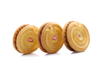sandwich cookies with strawberry cream on white background