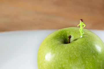 Miniature woman in a diet and fitness concept