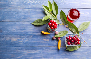 Composition with fresh cherry and juice on wooden background