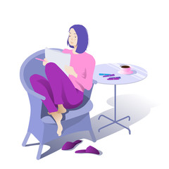 The girl draws sitting in a comfortable chair at home in a cafe