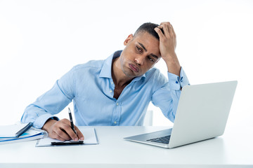 Desperate young businessman working on laptop going crazy with loads of work